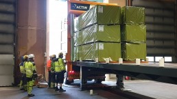 People watching loading the gluelam packages to a sea container.